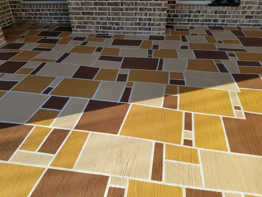 Colorful patterned concrete floor featuring brown, yellow, and beige geometric shapes.